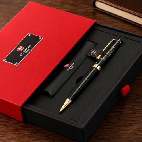 A black and gold pen presented in an open black gift box with a red lid, placed on a wooden surface. The box lid has a red cover with a black plaque reading 'SOTI SWISS MADE'.