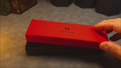 A gift box opening to reveal a custom engraved brass ballpoint pen