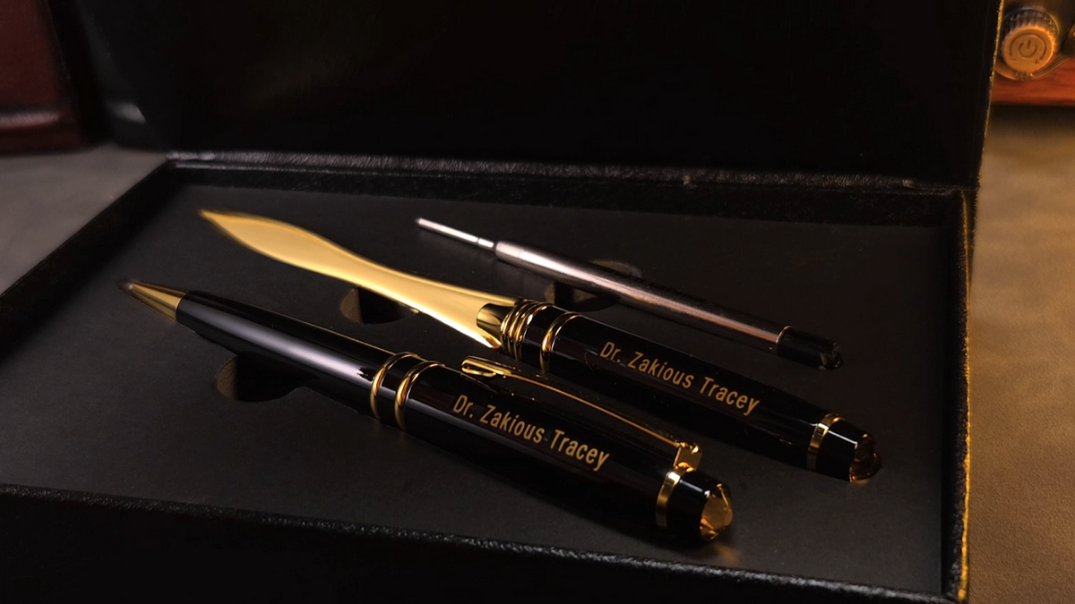 The box opens to display a personalized pen and a matching letter opener.