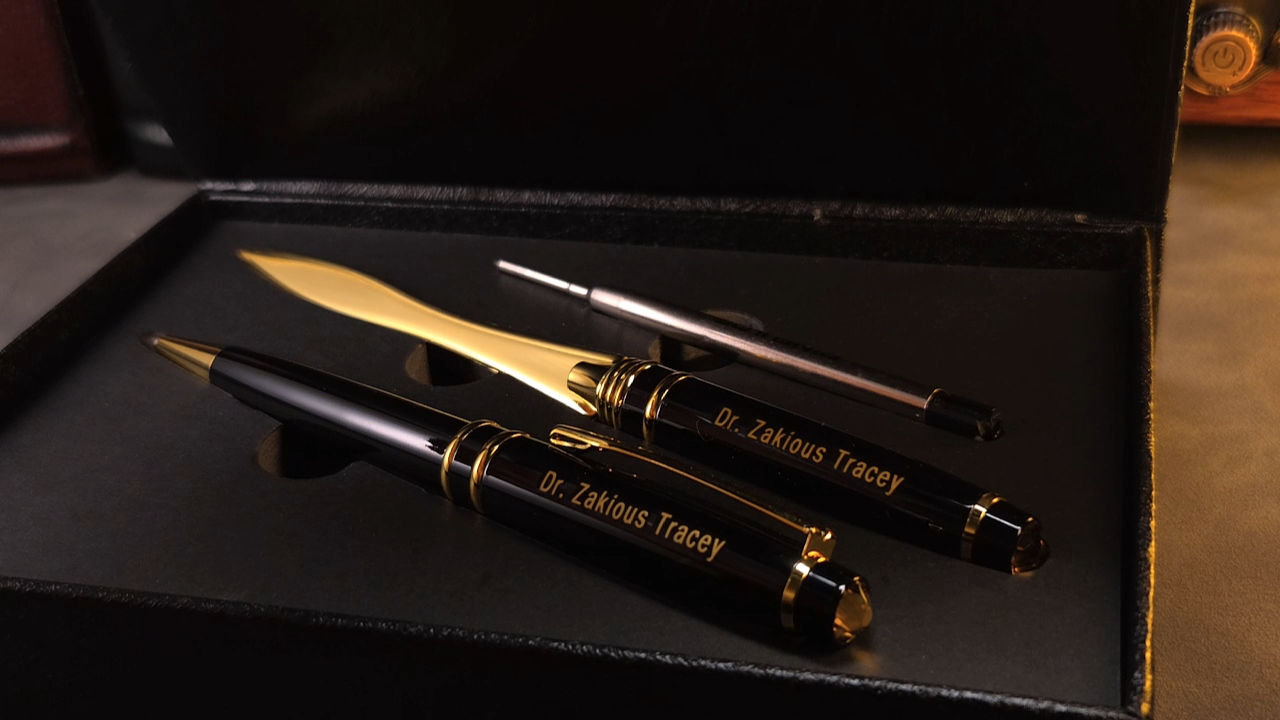 The box opens to display a personalized pen and a matching letter opener.